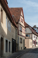 Fototapeta na wymiar ROTHENBURG OB DER TAUBER, GERMANY - MARCH 05, 2018: Historic colorful half-timbered houses in the medieval town Rothenburg ob der Tauber, one of the most beautiful villages in Europe, Germany