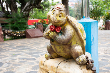 Fototapeta na wymiar Tortoise or turtle statue for chinese people and foreigner travelers visit in garden at Zhongshan public park at Shantou or Swatow city in Guangdong, China