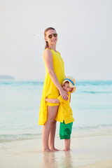 Toddler boy on beach with mother