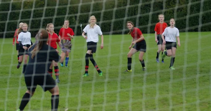 4K Disappointed goalie fails to make a save at girls' football match. Slow motion.