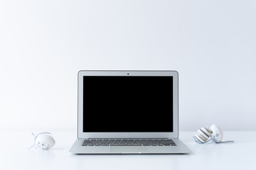 Open laptop and easter eggs on the desk with white background