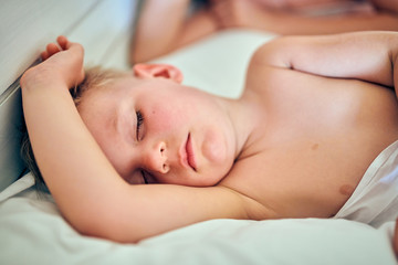 Fototapeta na wymiar Toddler boy sleeping on pillow with mother