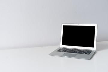 Open laptop on the desk with white background