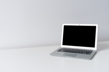 Fototapeta premium Open laptop on the desk with white background