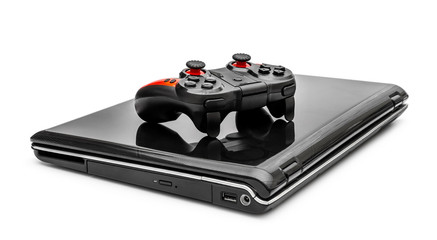 Closed laptop with gamepad on white.