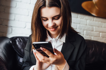 Staying in contact. Business woman using mobile. Close up.