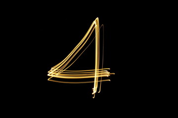 Long exposure, light painting photography.  Single number in a vibrant neon metallic yellow gold colour against a black background