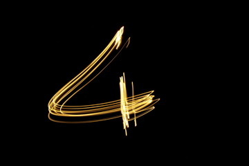 Long exposure, light painting photography.  Single number in a vibrant neon metallic yellow gold...