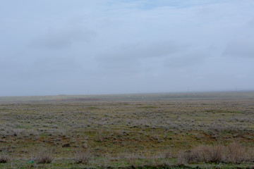 Fototapeta premium Landscape of wild Kalmyk steppe in a fog