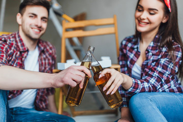 Yong couple drinking beer in new apartaments!