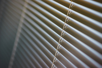 Details of the modern interior blinds on the window.