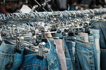 jeans  on hangers, second hand  store, trousers closeup