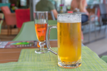 Glass of light beer on a restaurant table close