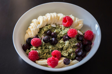 Matcha  Oatmeal porridge with ripe berries and banana