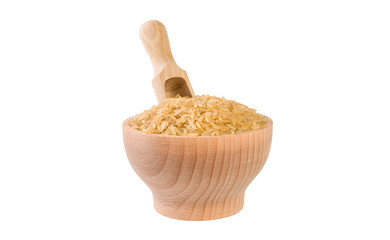 brown rice in wooden bowl and scoop isolated on white background. nutrition. bio. natural food ingredient.front view.