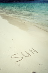 Love and romance. The inscription on the sand. Holidays by the sea.