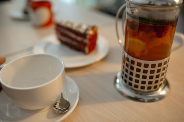 tea with a teapot is on a bright table