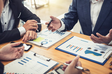 Businessman present graph financial information at the meeting.