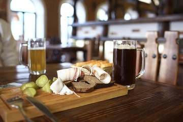 two beer mugs in a Czech beer restaurant / light and dark beer in large mugs traditional Prague pub