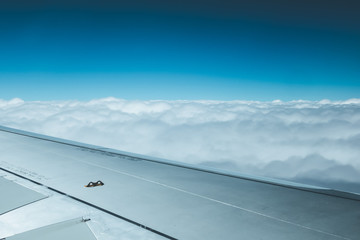 Fototapeta na wymiar Airplane wing through the aircraft window. Greenhouse effect, global warming.