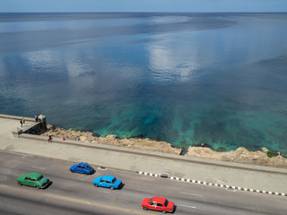 Classic cars driving down the Malcon in Havana, Cuba, aerial view