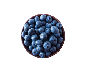 Blueberries in a wooden bowl. Ripe blueberries with copy space for text. Blueberry isolated on white. Bilberries  on a white background. Top view.