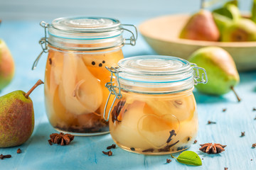 Preparation for fresh pickled sweet pears on blue table