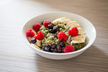 Matcha  Oatmeal porridge with ripe berries and banana