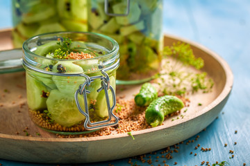 Closeup of homemade canned cucumber on blue table