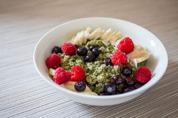 Matcha  Oatmeal porridge with ripe berries and banana