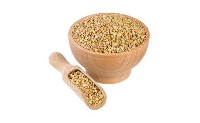 raw buckwheat in wooden bowl and scoop isolated on white background. nutrition. bio. natural food ingredient.
