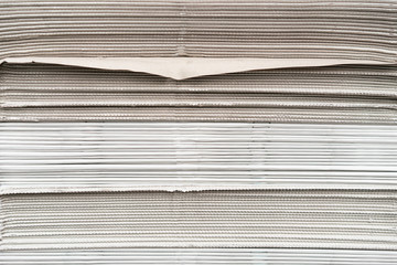 close up newspapers folded and stacked background on the table