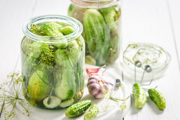 Preparation for fresh pickled cucumber in summer on white table