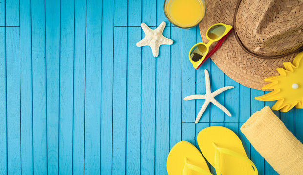 Summer holiday vacation background with beach accessories on wooden table.