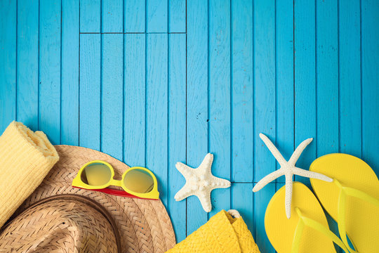 Summer holiday vacation background with beach accessories on wooden table.