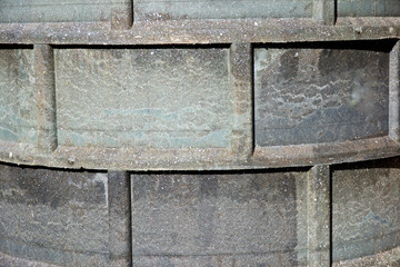 A fragment of the ring of the inspection sewer manhole made of polymer sand mixture.