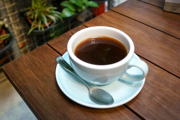 Black coffee on wooden table