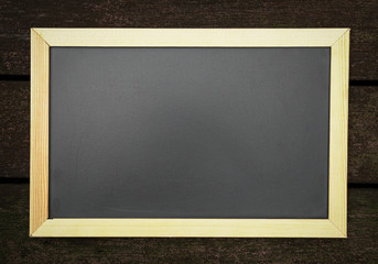 Abstract blackboard or chalkboard with frame on dark wood background