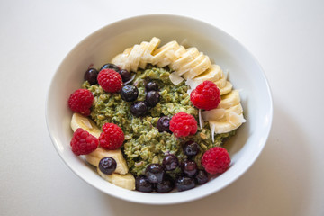 Matcha  Oatmeal porridge with ripe berries and banana