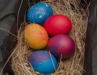 Fototapeta na wymiar Multi-colored chicken eggs lie on the hay. Easter.