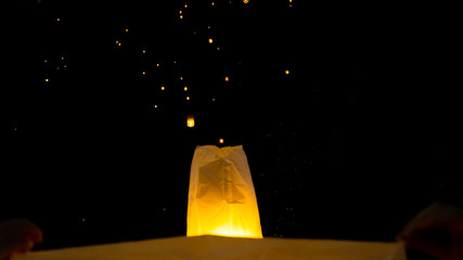 Chiang Mai Lantern Festival, time of celebration for Thailand. Two close up Lanterns floating off to join the others lighting up the sky in a beautiful and unique arrangement looking like stars.