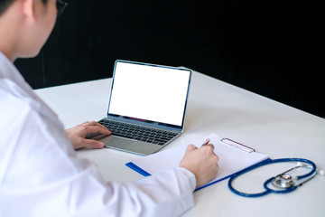 Young male doctor asian working with laptop in the office