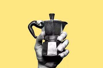 Poster Making italian coffee. Hand holding an old, vintage italian coffee maker in black and white. Isolated. Yellow background © Andrew Stripes