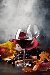 Keuken spatwand met foto Red wine in wine glass, autumn still life with red and yellow leaves, wine tasting, copy space, selective focus © 5ph