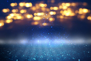 glitter vintage lights background. black, gold, silver and blue. de-focused