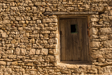 A wooden door in a stone house