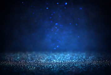 glitter vintage lights background. black silver and blue. de-focused