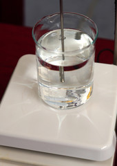 Closeup of stirrer in glass flask laboratory background