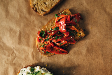 Roasted red peppers on a toasted bread with parsley and olive oil
