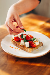 Chef preparing caprese bruschetta in the kitchen